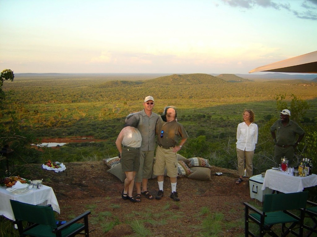 Sundowner drinks on a rocky hilltop overlooking the African bushveld during the 2004 VIP safari